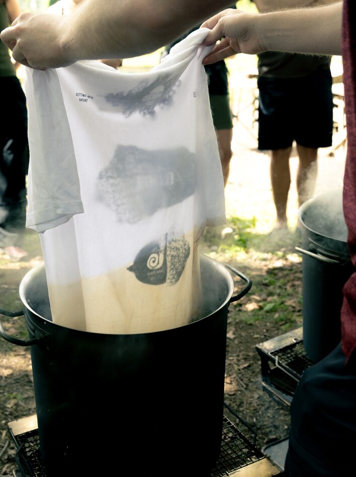 Pulling ELLIKER Tshirt from Natural Dying Pot